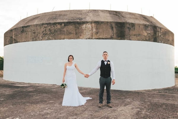 Bride and groom holding hands