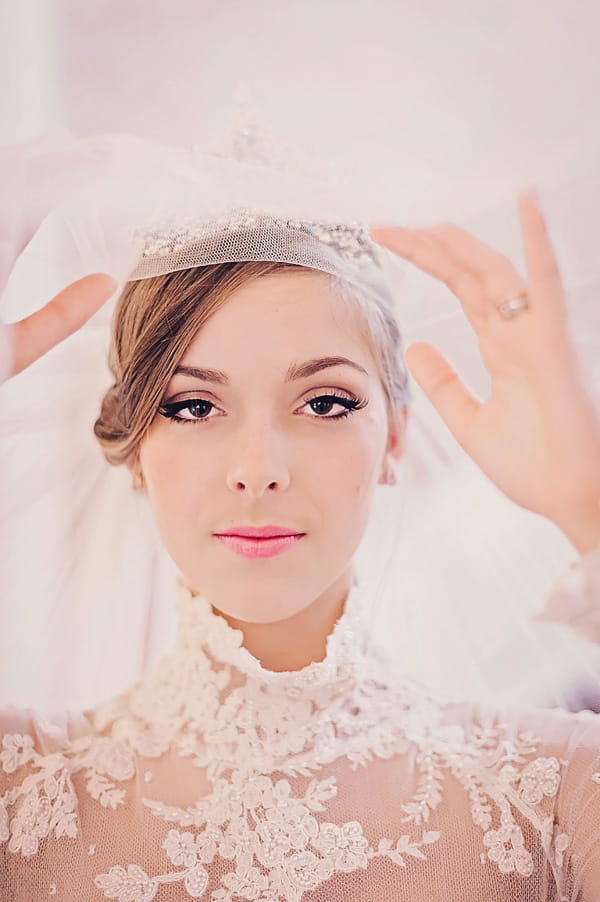 Bride lifting veil