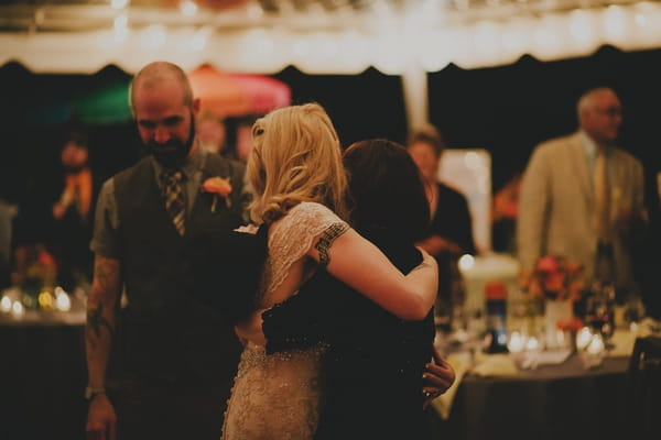 Bride hugging woman