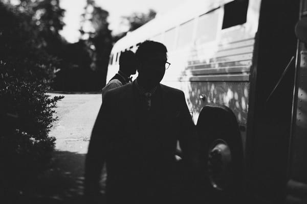 Man walking past bus