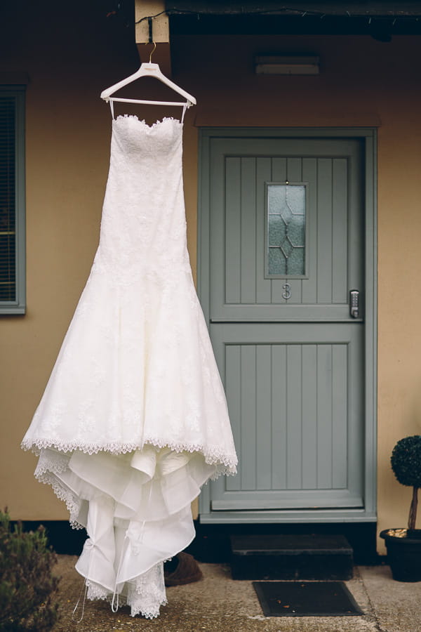 Wedding dress hanging by door