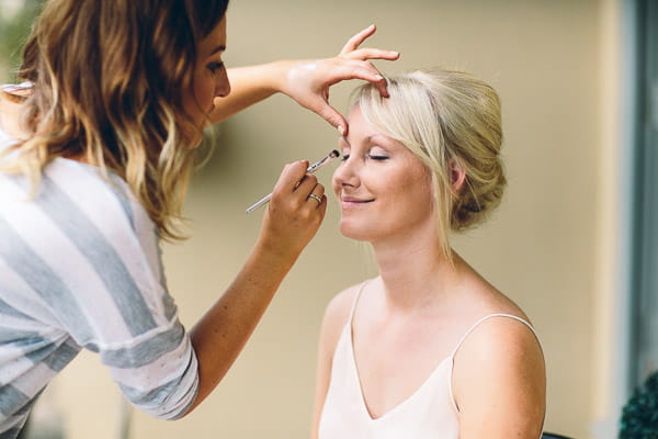 Bride having eye make-up done