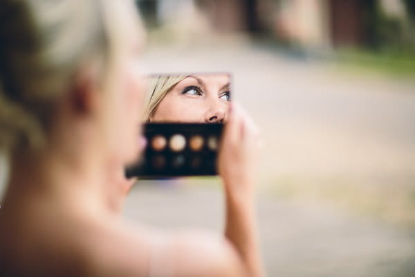 Reflection of bride in make-up mirror