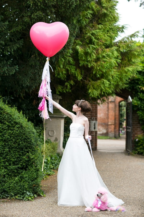 Bride holding pink balloon