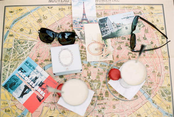 Sunglasses and pictures of Paris on map