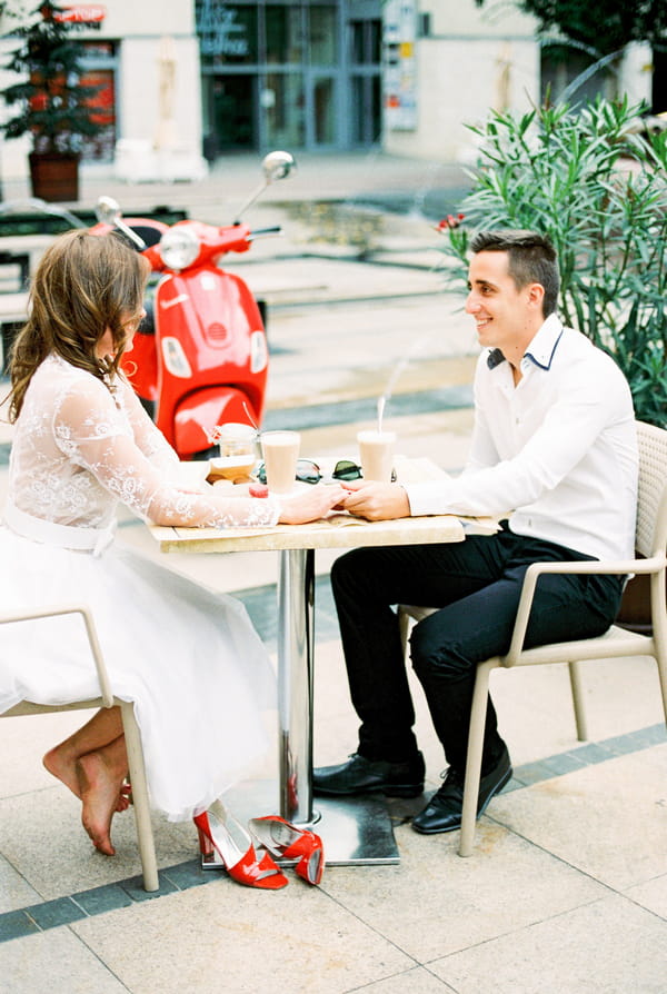 Couple sitting at cafe table in Paris