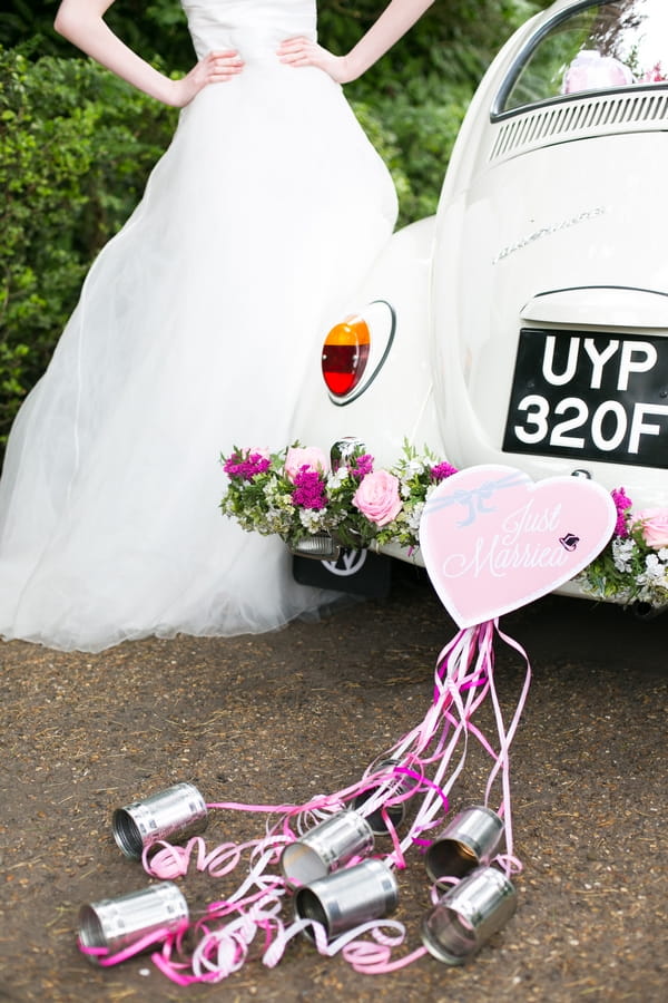 Heart and cans tied to back of VW Beetle