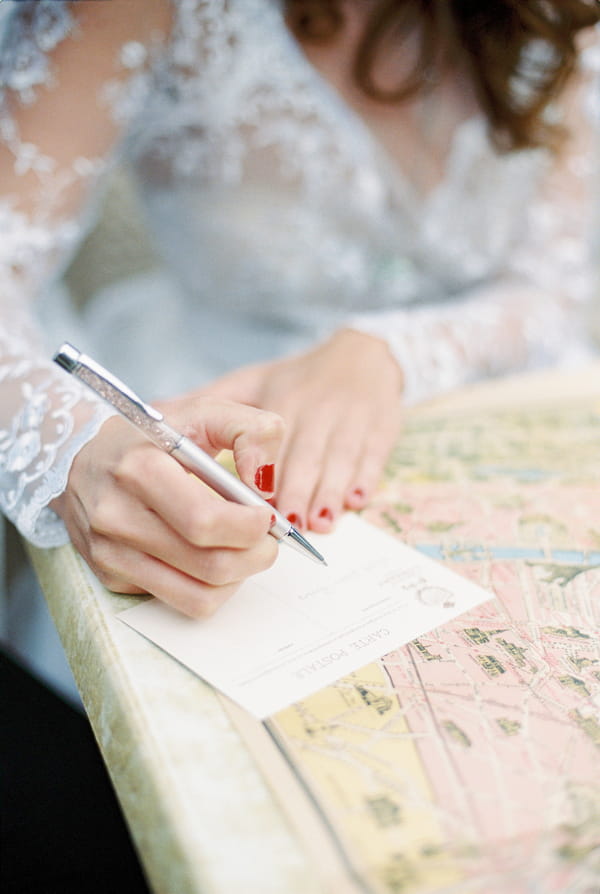 Bride writing postcard