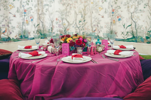 Low-lying wedding table with pink tablecloth