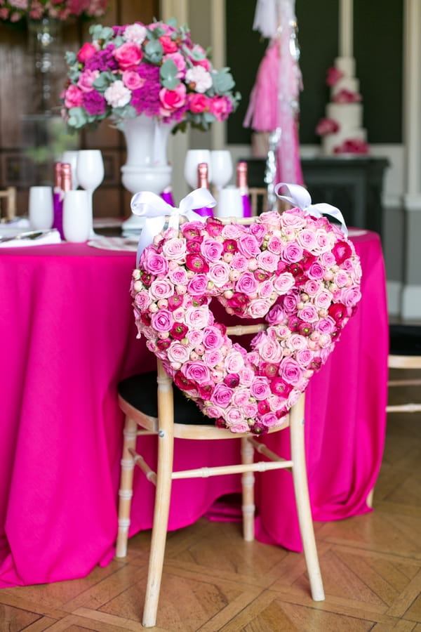 Pink floral heart wreath on back of chair