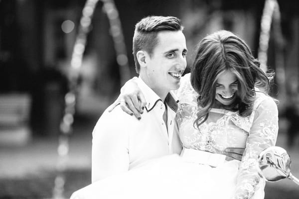 Groom holding bride