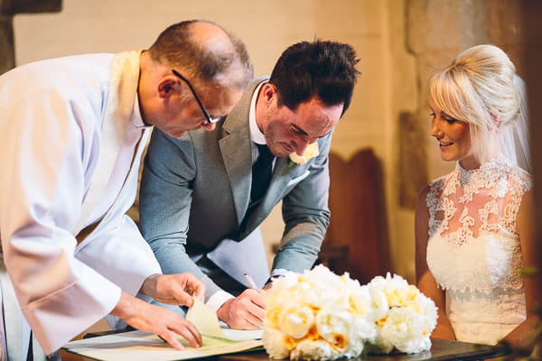 Groom signing marriage register