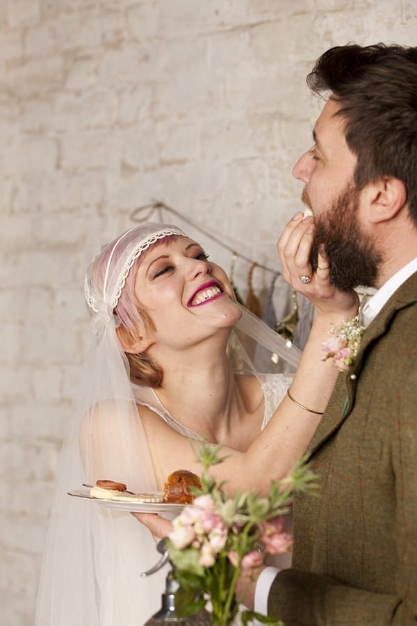 Bride feeding groom cake