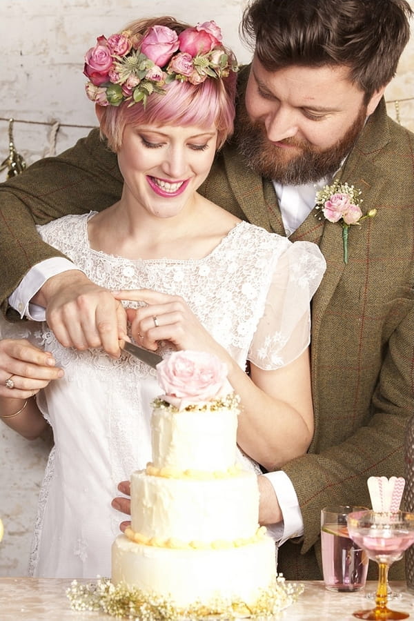 Bride and groom cutting cake