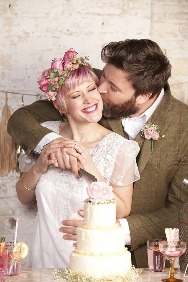 Groom kissing bride on cheek