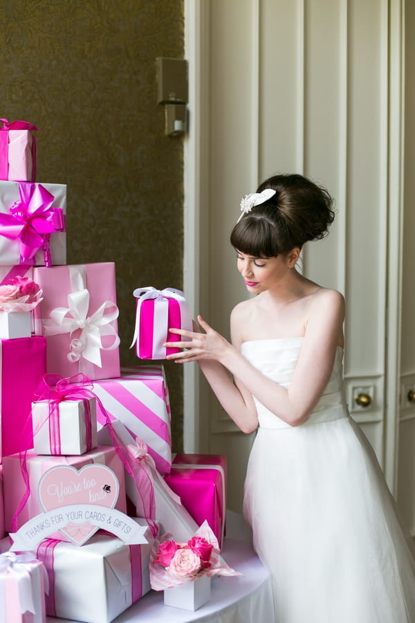 Bride placing present on pile