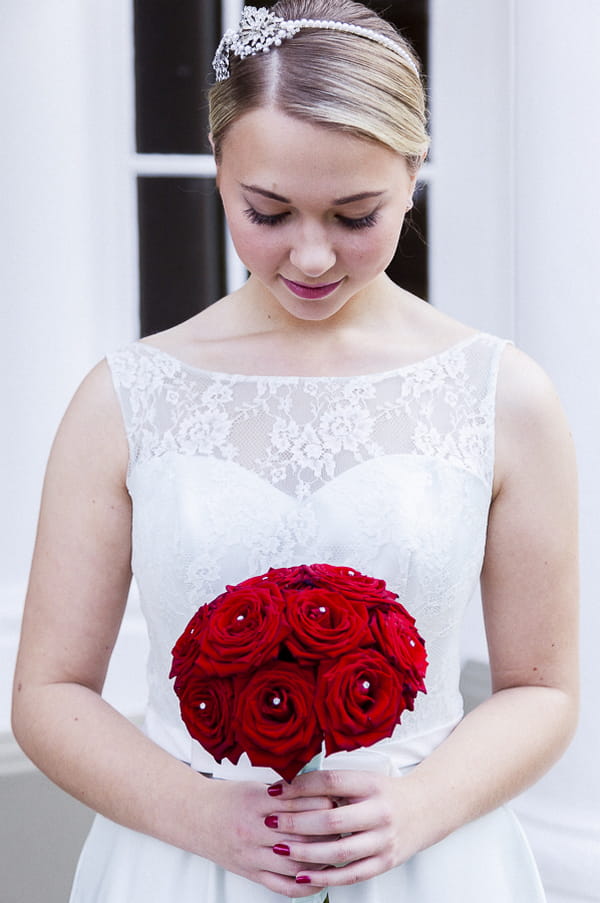 Bridesmaid holding red rose bouquet