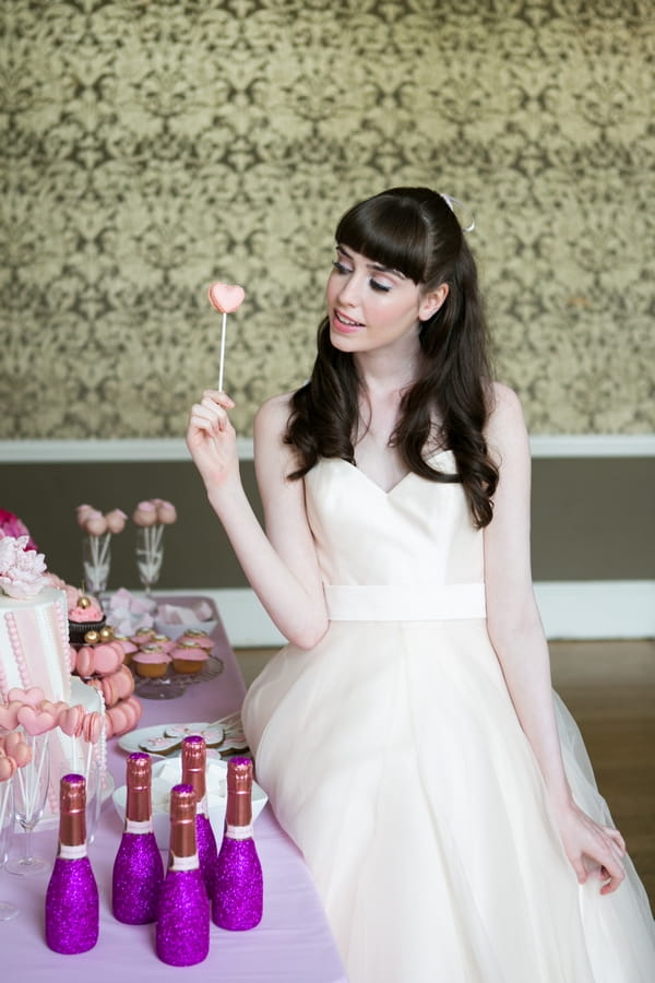 Bride holding cake on stick