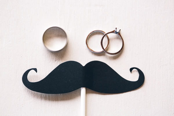 Wedding rings and moustache on stick