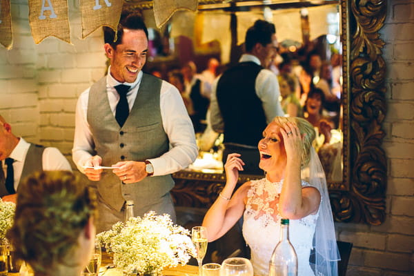 Bride laughing at groom speech