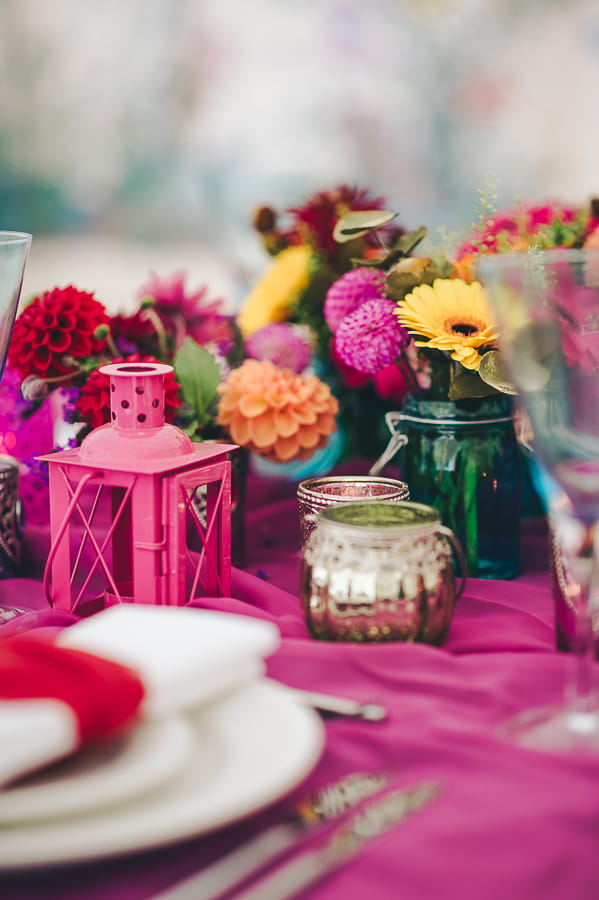 Brightly coloured wedding table flowers and accessories