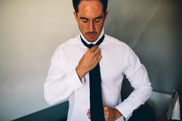 Groom doing up tie