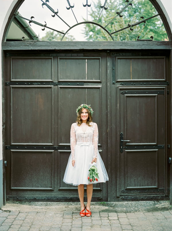 Bride standing holding bouquet