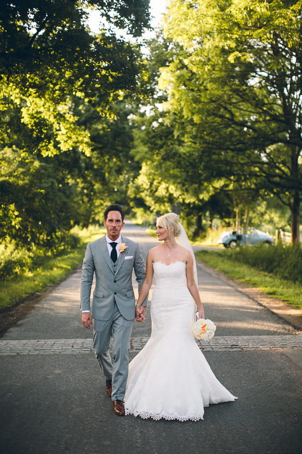 Bride and groom walking holding hands