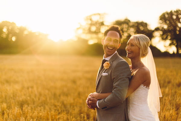 Bride with arms around groom's waist