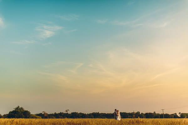 Bride and groom in field