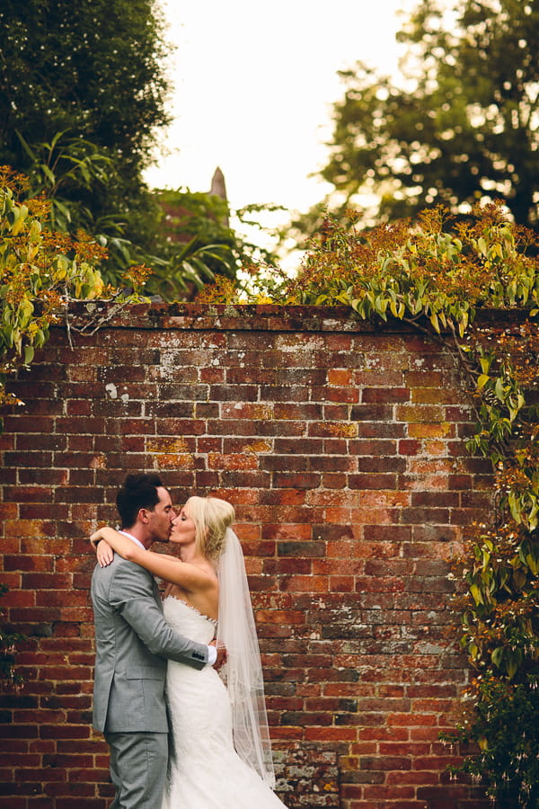 Bride and groom nest to wall