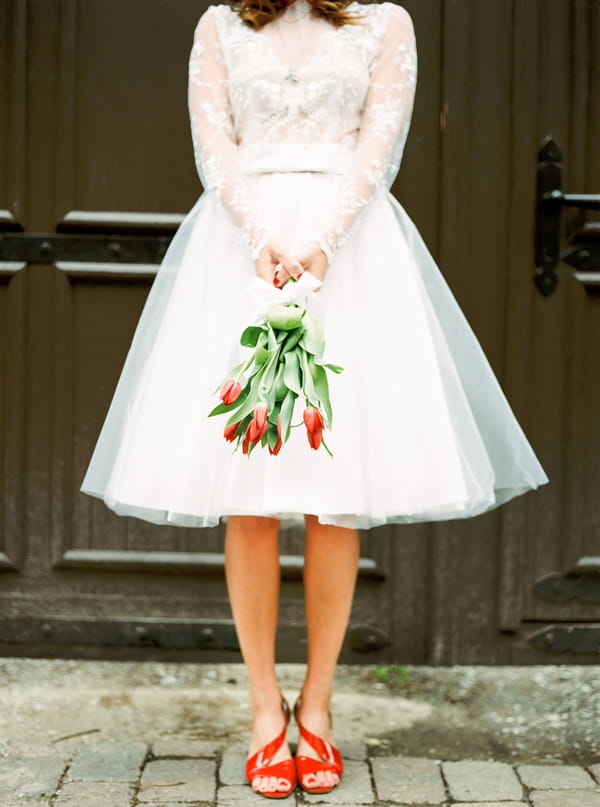 Bride holding red tulips