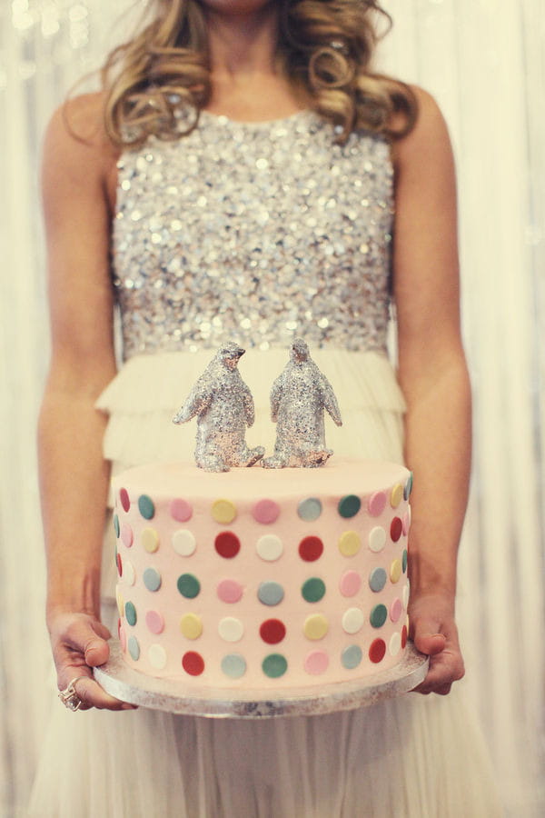 Bride holding spotty wedding cake