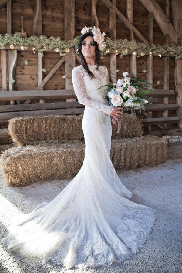 Bride holding bouquet in barn
