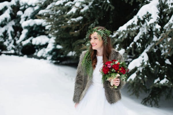 Bride holding bouquet in snow