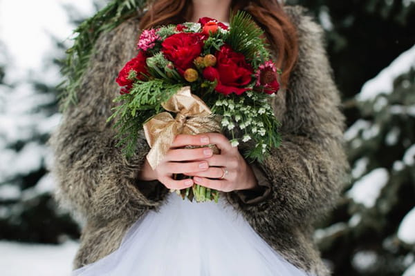 Bride holding Christmas wedding bouquet