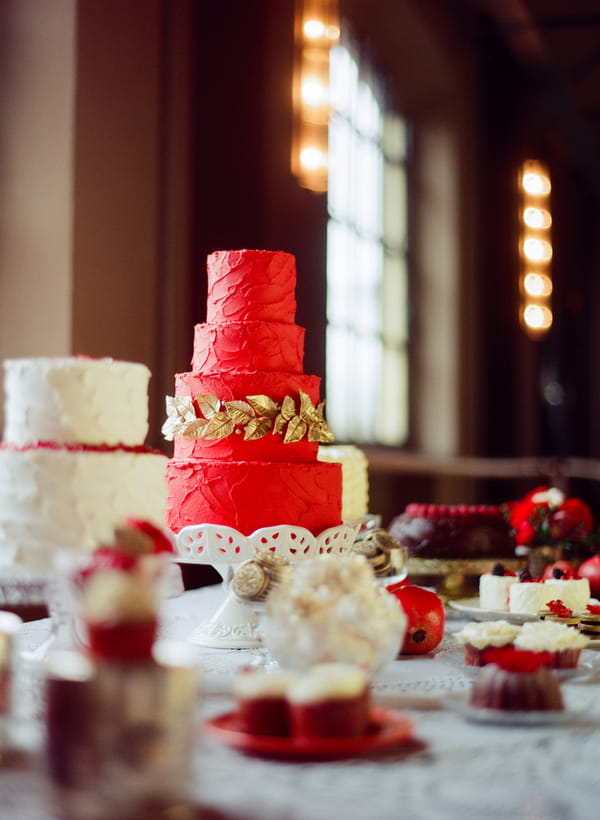 Red wedding cake with gold leaf detail