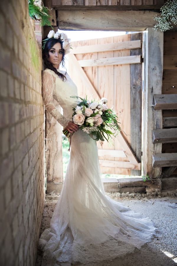 Bride leaning against wall