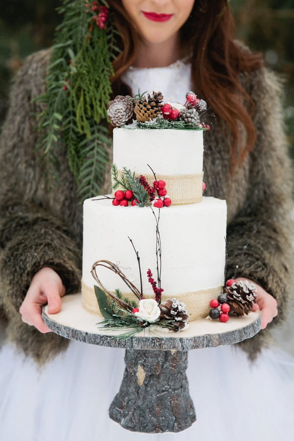 Bride holding Christmas wedding cake