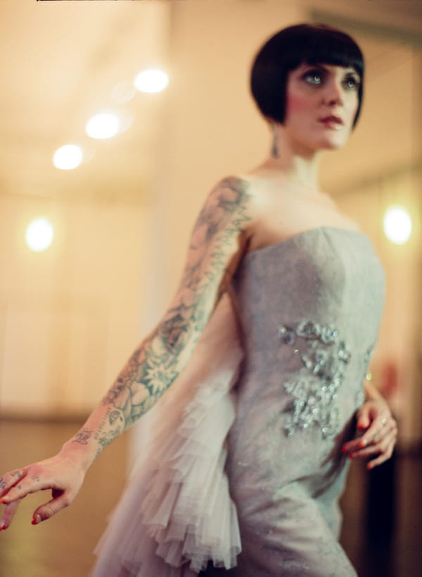Bride with bob and tattoos wearing silver wedding dress