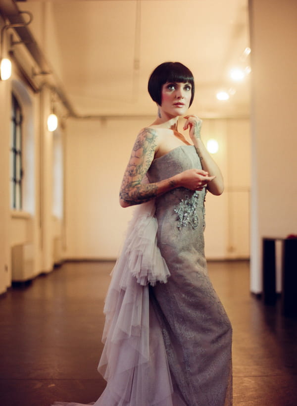 Bride with bob and tattoos wearing silver wedding dress