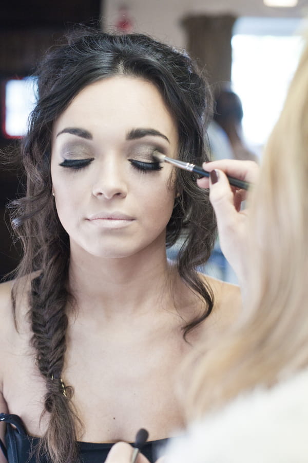 Bride having mascara applied