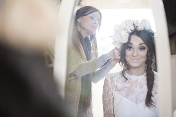 Bride putting on large floral headpiece