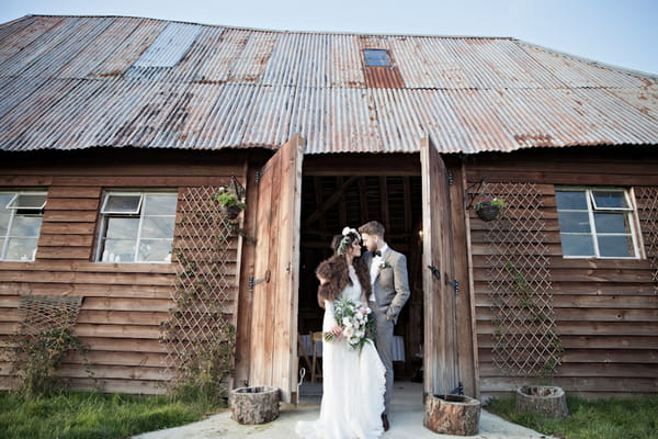 Bride and groom outside Horseshoes Barn, The House Meadow