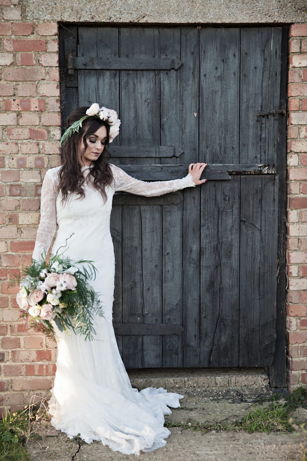 Bride leaning on barn door