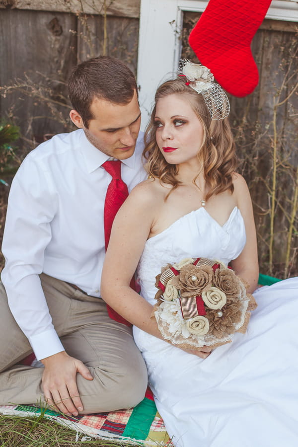 Groom sitting with bride holding bouquet