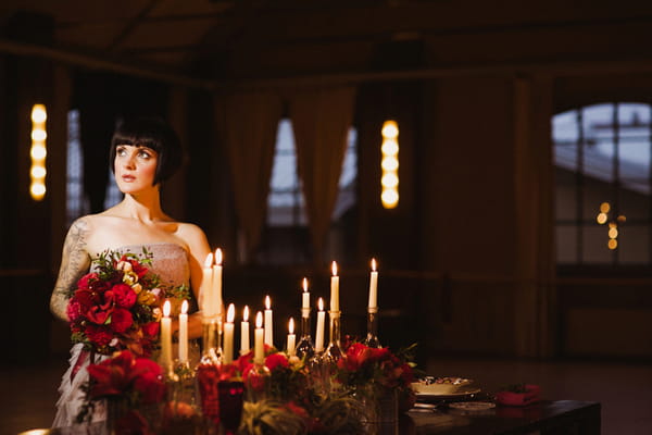 Bride sitting next to candles