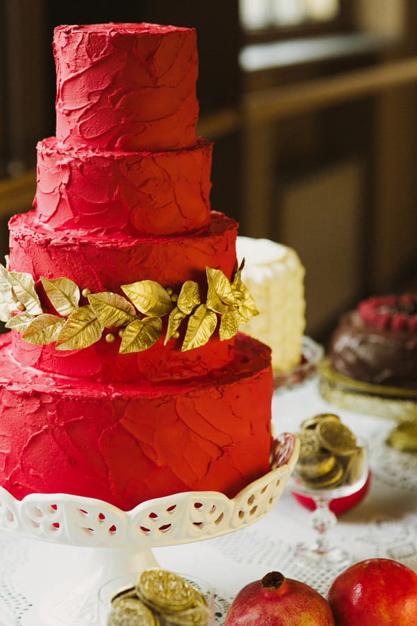 Red wedding cake with gold leaf detail