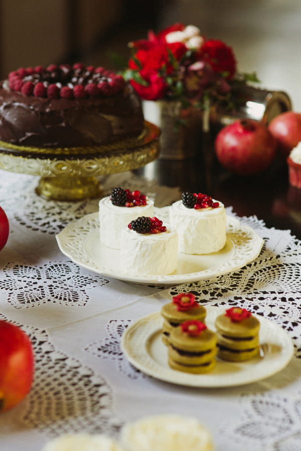 Small white cakes with red berries