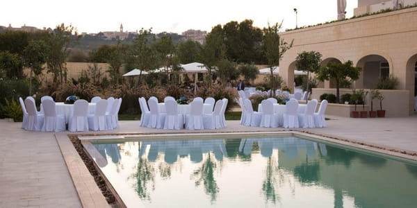 Reception Seating by Pool at The Xara Lodge Wedding Venue in Malta